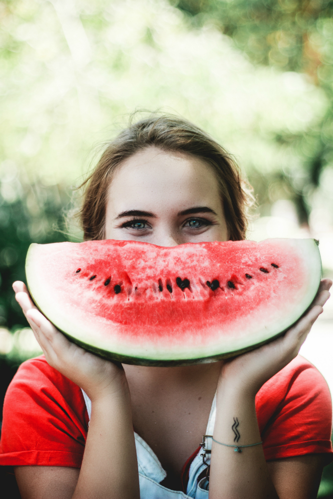 A woman eating watermelon