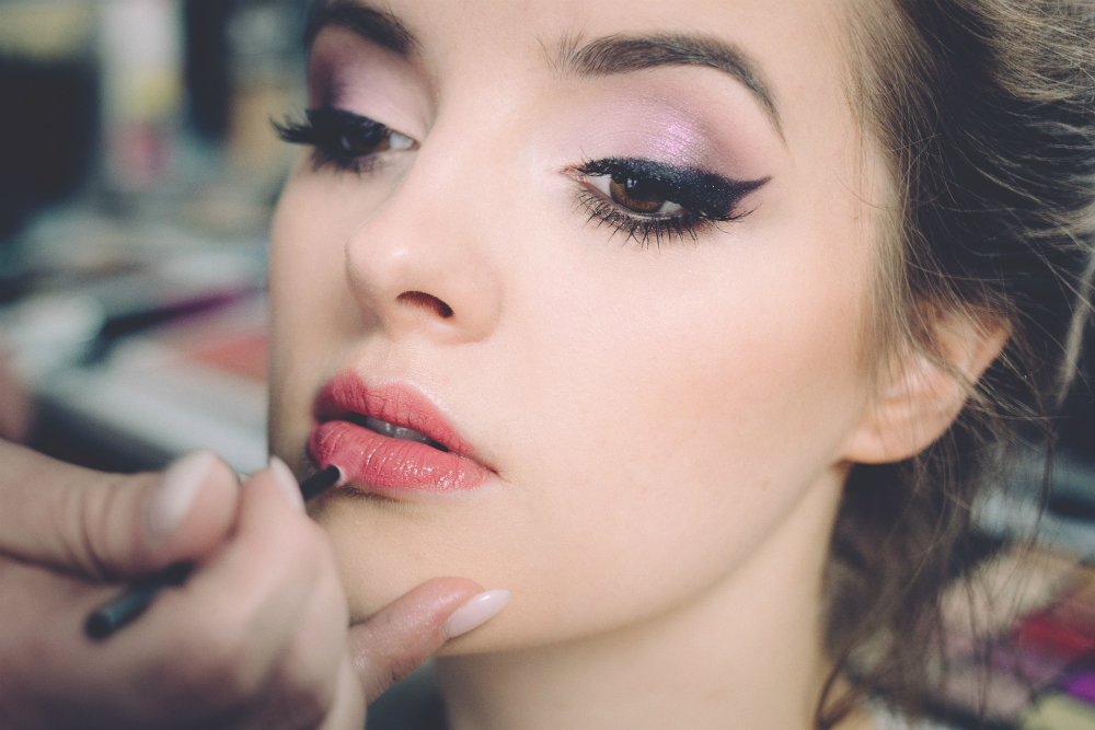 applying make-up to a woman