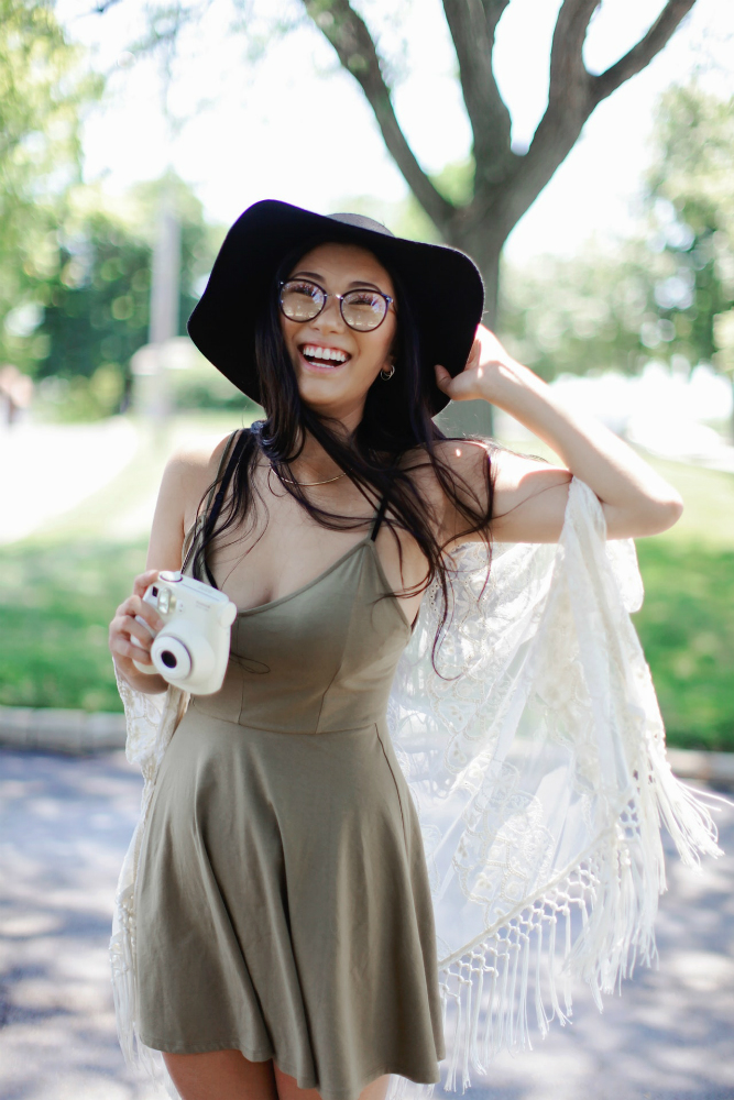 A woman wearing a casual sage-colored dress