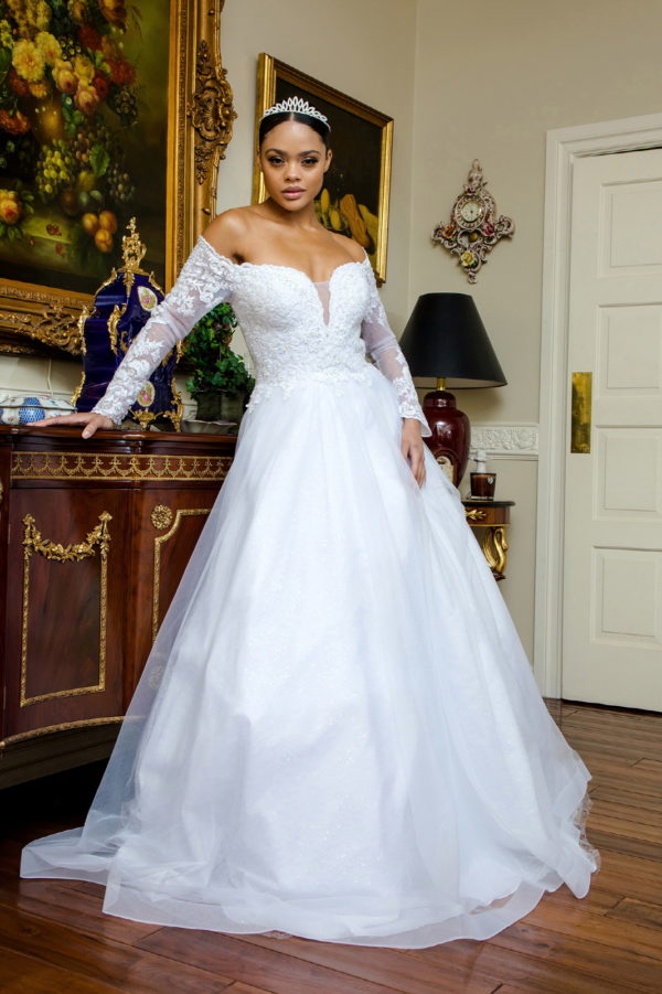 woman in off shoulder long sleeve wedding gown