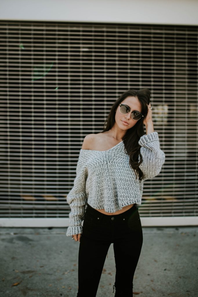 woman in sweater and dark jeans