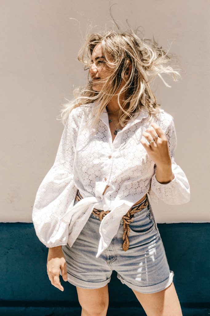 woman in denim shorts an white top