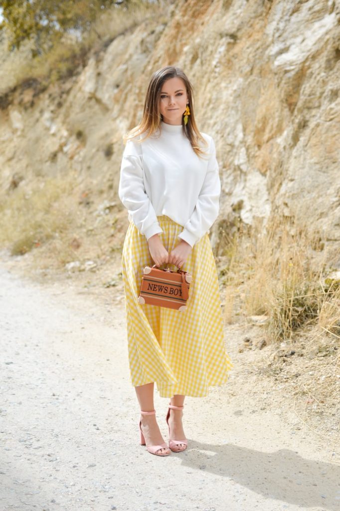 girl in white sweater and yellow skirt