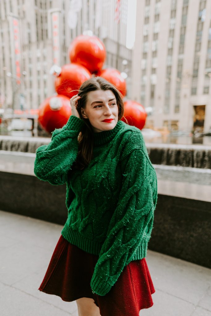 girl in oversized sweater and red skirt