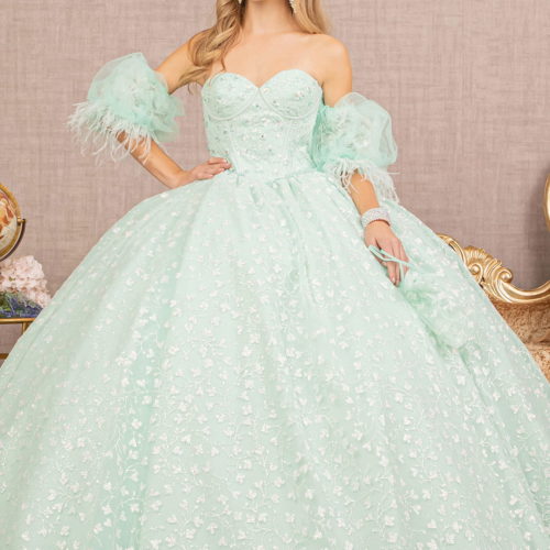 Girl in a mint strapless sequin Quinceanera gown w/ feathers