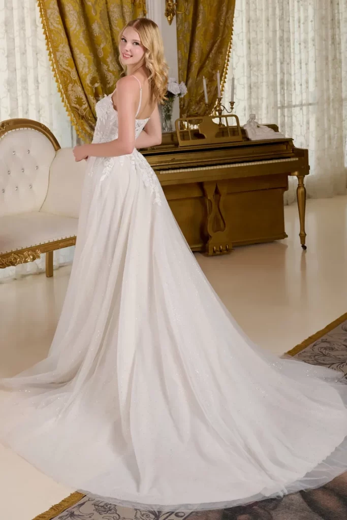 side view of a woman in an embroidered white sequin dress 