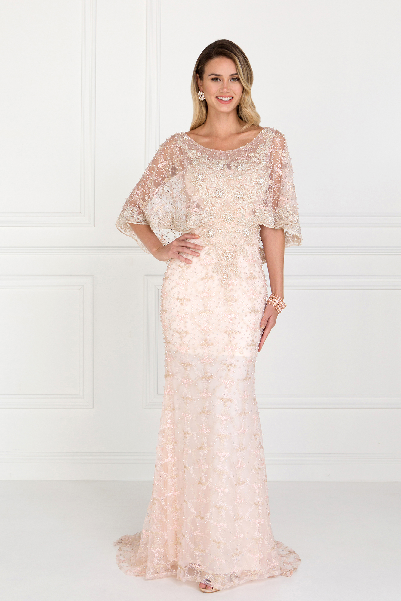 woman in blush gown with cape sleeve